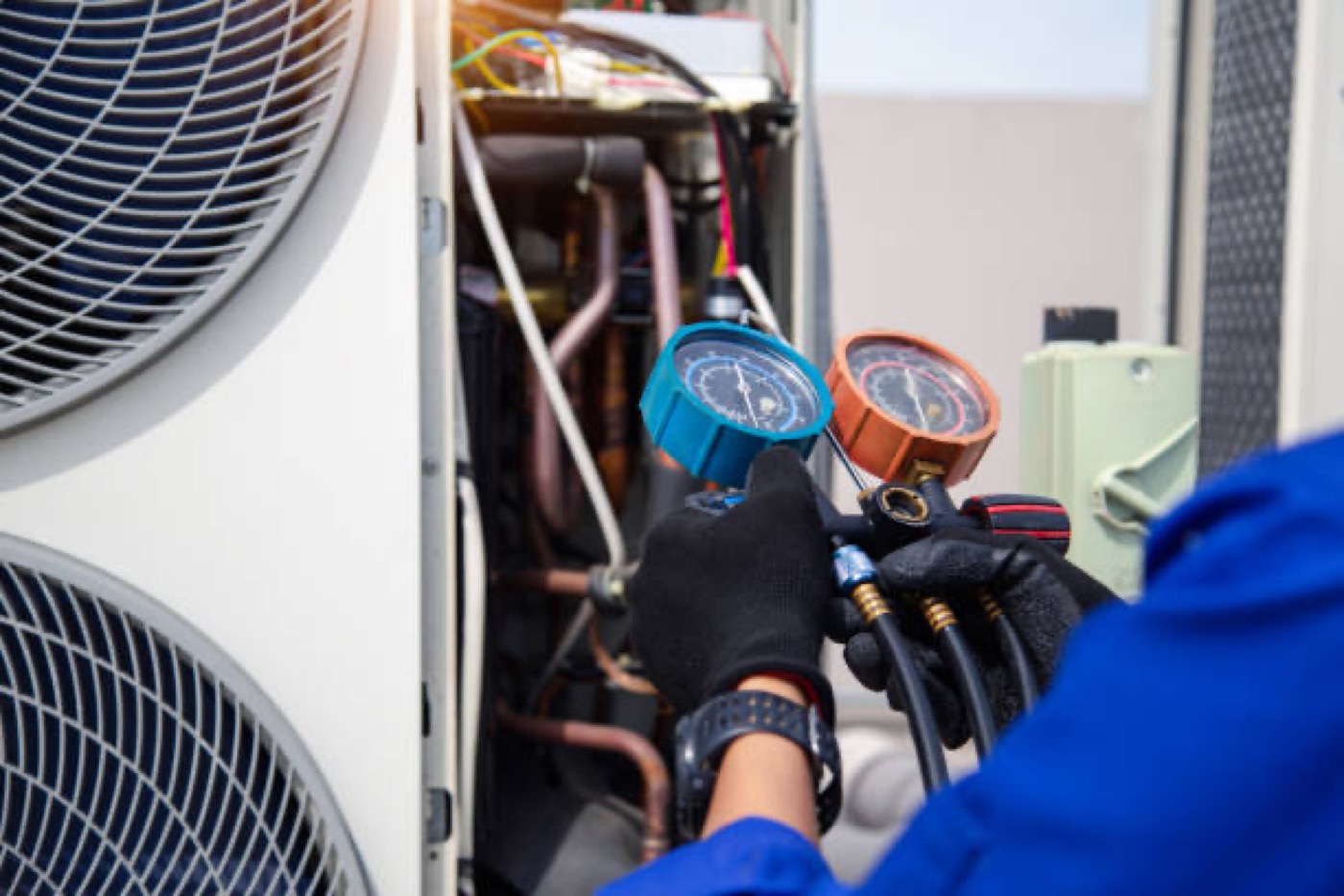 Technician checking refrigerant pressure